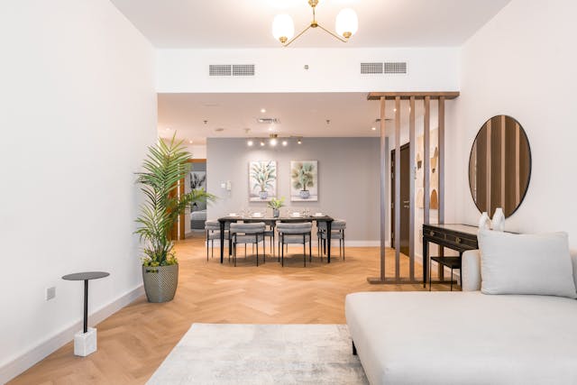 interior of a living room featuring a couch dining table and wooden floor