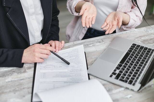 two person discussing with a pen and paper